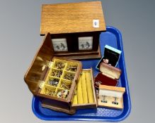 Two wooden jewellery boxes containing cufflinks.