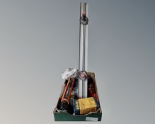 A box of tools including silicon gun, wire mesh.