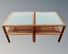 A pair of teak and glass topped square lamp tables.