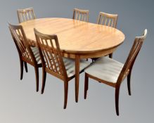 A 20th century G plan teak oval extending dining table together with a set of six railback dining