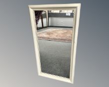 A contemporary cream mirror, 49cm by 89cm.
