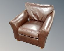 A contemporary brown leather armchair.