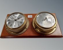 A clock and barometer mounted on board.