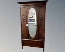 An Edwardian mirrored single door wardrobe,