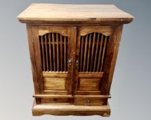 A stained pine entertainment cabinet,