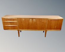 A Mcintosh furniture teak low sideboard, fitted with cupboards and drawers beneath.