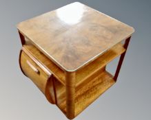 An Art Deco walnut cocktail occasional table.