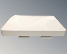 A contemporary travertine coffee table on twin pedestals.