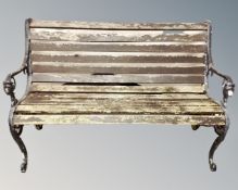 A black cast iron wooden slatted garden bench.