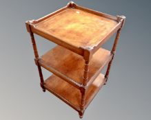 A mahogany three tier occasional table.