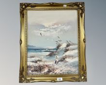 Continental school : Child seated in a dune, oil on canvas, indistinctly signed, 39cm by 50cm.