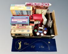 A box containing assorted games including Cluedo, Scrabble, Jigsaws,