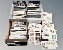 Two boxes containing a large quantity of British stamps, First Day Covers and Royal Mail postcards.