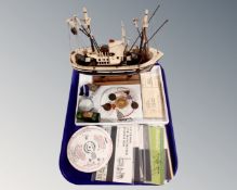 A tray containing stamp packs, enamelled badges, Freemason's badge,