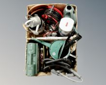 Two boxes containing a cased drill, watering cans, extension lead,