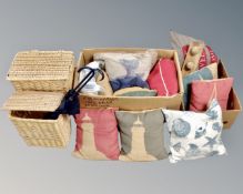Two boxes containing assorted cushions together with two graduated wicker laundry baskets