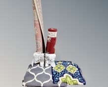 A wicker basket containing assorted rugs and runners.