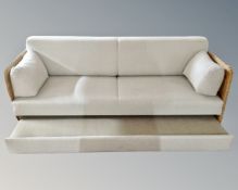 A wicker framed conservatory settee.