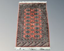A Tekke rug on salmon ground, 82cm by 120cm.