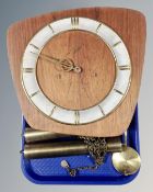 A 20th century teak wall clock with pendulum and weights.