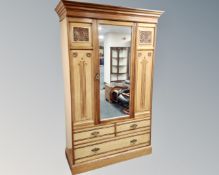 An Edwardian satinwood mirror door wardrobe.