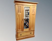 An Edwardian satinwood mirror door wardrobe.