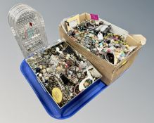 A tray of two boxes containing assorted costume jewellery and a folding plastic jewellery stand.
