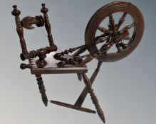 A miniature antique spinning wheel.