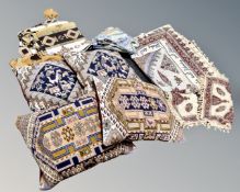 Two boxes of four kilim cushions and further eastern fabrics