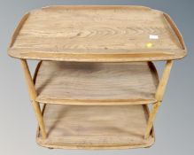 An Ercol elm three tier drinks trolley.