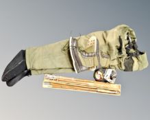 A box of assorted fishing items, pair of waders, boots, reel, lures,