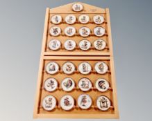 A German Hummell Goebel display stand containing twenty five plates