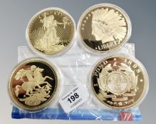 Four oversized commemorative coins - USA 20 Dollars etc (4)