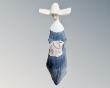 A Lladro figure of a seated nun doing embroidery, #5501.