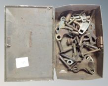 A tin containing antique clock keys.