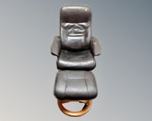 A contemporary swivel armchair and matching footstool in brown leather upholstery.