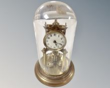 A brass anniversary clock under dome.