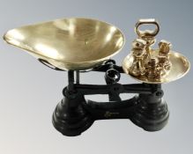 A set of Ibrasco painted metal scales with a set of graduated brass weights.