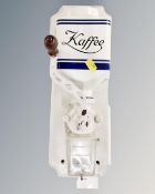 A vintage continental wall mounted coffee grinder