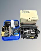 A Canon UC5000 8mm video camcorder together with a tray containing Panasonic Diskman,