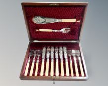 An Edwardian mahogany canteen of fourteen-piece fish cutlery set