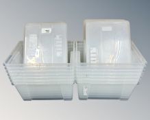 A collection of 14 IKEA plastic storage boxes with lids.