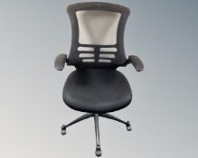 An adjustable office armchair in black mesh fabric