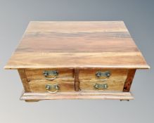 An Asian hardwood block coffee table fitted with drawers.