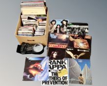 A box of vinyl records to include LP's and 7