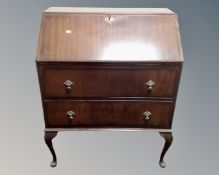 A mid century writing bureau on Queen Anne style legs