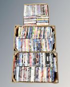 Three boxes containing a quantity of DVDs.