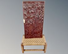 A carved hardwood frieze panel together with a rush seated stool