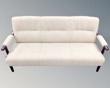 A Scandinavian stained beech framed settee, in oatmeal fabric,