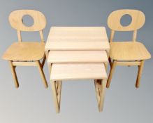 A nest of three beech effects tables and a pair of child's chairs